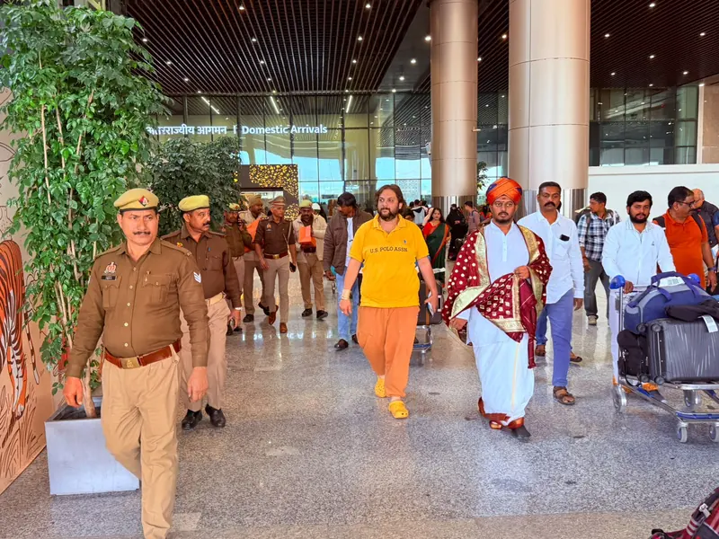 A group walking through an airport terminal with a police escort