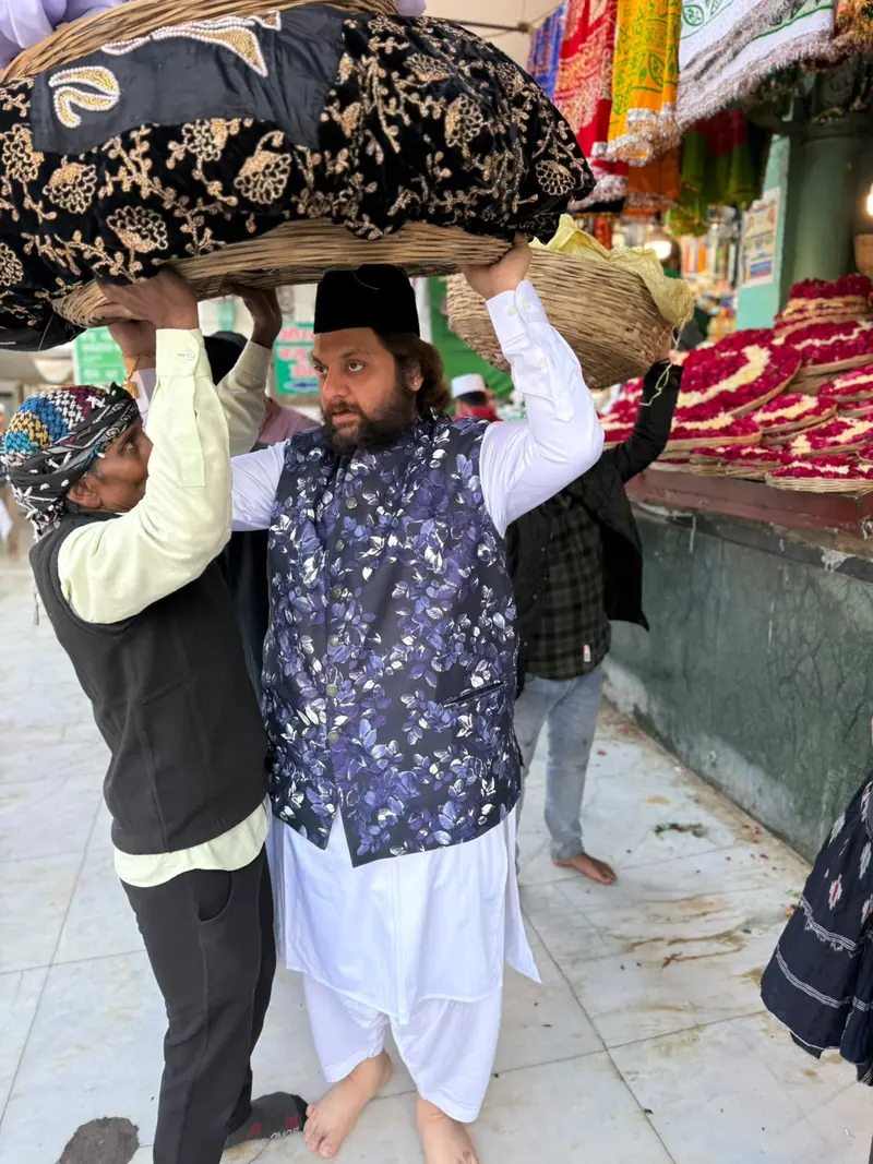A man carrying a ceremonial cloth through a market